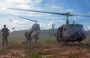Bell Huey Helicopter in flight Soldiers exiting UH1 Huey Helicopter in Vietnam War